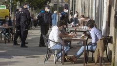 En una imagen de archivo, agentes de la Polic�a Local y de la Nacional patrullan conjuntamente por Santiago para vigilar el cumplimiento de las restricciones por la pandemia