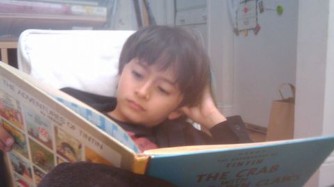 Un neno lendo un libro de Tint�n