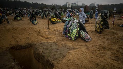 Familiares asisten hoy al entierro de una persona que muri� en un refugio subterr�neo mientras se intentaba proteger de los bombardeos, en Irpin (Ucrania)