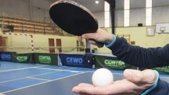 Una pala y una pelota de tenis de mesa
