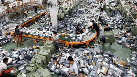 Operarios trabajan en una abarrotada planta log&iacute;stica de Aliexpress en China