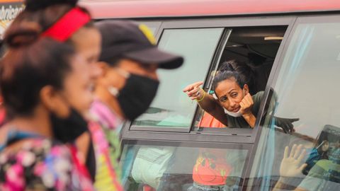 Una mujer se asoma por la ventana de un bus del operativo de retorno de desplazados venezolanos, en San Antonio del Tchira 