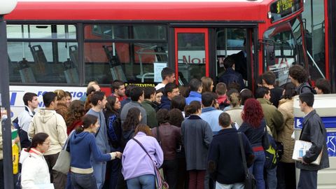 Estudantes da Universidade da Coruña facendo cola para coller o bus urbano na parada da rotonda de Socioloxía en novembro de 2002