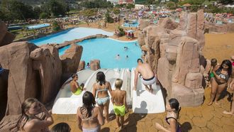 1 Numerosos ni�os y ni�as hacen cola en una de las piscinas con toboganes infantiles del Aquapark de Cerdeda.