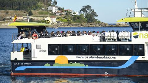 Turistas disfrutan del buen tiempo en el barco que conecta con la isla de Ons.