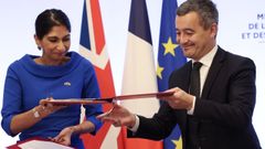 La brit�nica Suella Braverman  y franc�s G�rald Darmanin intercambian el acuerdo firmado.
