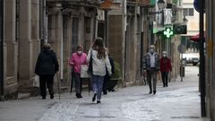 Transe�ntes con mascarillas en la calle Comercio de Monforte