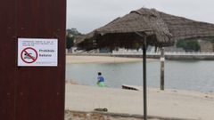 Carteles en la playa de O Preguntoiro anunciando la prohibici�n de ba�arse este semana