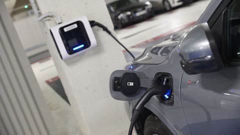 Coche el�ctrico cargando en un aparcamiento