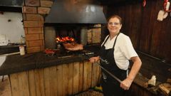 Marina Timiraos junto a la parrilla de ladrillo refractario de su negocio, que es nica
