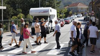 Vecinos de Hio ocupando un paso de cebra como protesta
