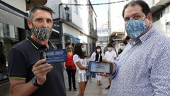Javier Tri�anes y Antonio Mart�nez muestran el dispositivo en sus tel�fonos m�viles