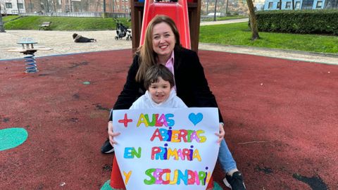 Lidia Prieto junto a su hijo Juan posando con una pancarta reivindicativa