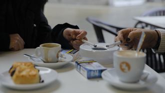 Imagen de archivo de dos personas fumando en una terraza. 