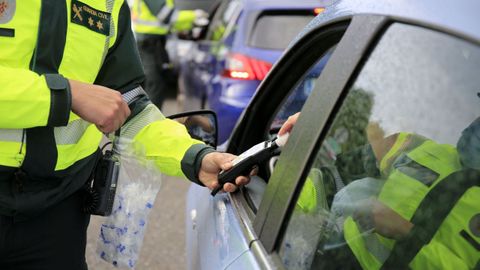 Un guardia civil realiza una prueba rpida de alcohol a un conductor en el corredor de Monforte.