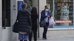 Vecinos de Arteixo hacen cola para entrar en un comercio de la calle peatonal