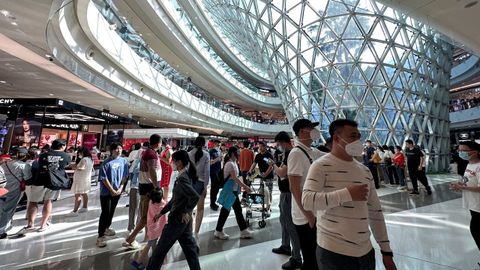 Imagen de archivo de clientes con mascarilla en un centro comercial de Sanya, en la provincia china de Hainan