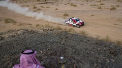 Un hombre saud observa el paso de Fernando Alonso durante la cuarta etapa del Dakar