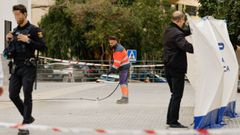 Un trabajador del Ayuntamiento de M�laga baldea la zona donde un hombre y una mujer han fallecido tras precipitarse desde un edificio