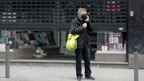 Una librer�a gallega con la verja a medio abrir, en el d�a en que se permit�a su reapertura