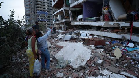 Dos mujeres observan el estado de un edificio en La Guaira, Venezuela
