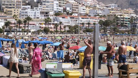 Turistas disfrutan del sol en la playa de las Vistas, situada en el municipio de Arona en Tenerife, uno de los principales núcleos turísticos de la isla