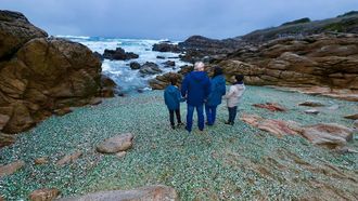 Una familia disfruta de la Praia dos Cristais de Laxe pese al tiempo desapacible.