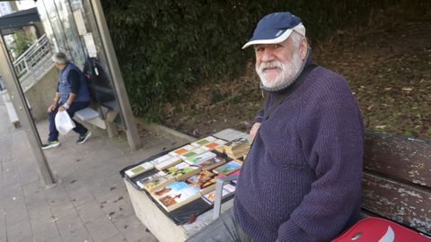 �lvaro Pazos, este mi�rcoles por la ma�ana, en el banco donde vende sus libros cl�sicos, junto a la parada de bus del Madrid-Par�s, en Ferrol.