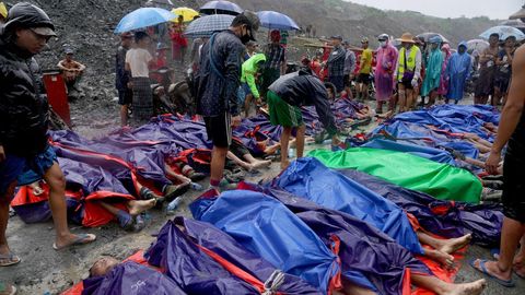 Amigos y familiares se reúnen al rededor de los fallecidos por el derrumbe de una mina en Birmania