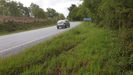 Un coche, circulando este martes por el lugar del accidente, en el que an se observaban las marcas del paso del vehculo siniestrado al salirse de la va