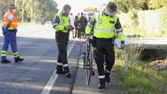 Agentes de la Guardia Civil examinan el lugar del accidente en el que muri� un ciclista este martes en Agolada