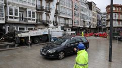 Coche pasando sobre la plaza de la Constituci�n mientras se ejecutan trabajos de hormigonado en el tramo en obras de la calle de la Iglesia.