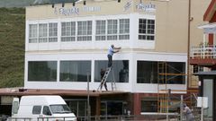 Operarios trabajando en la fachada del restaurante A Frouxeira