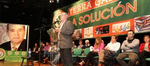 Andrade, con su equipo detr�s y dos enormes pancartas, interviniendo anoche ante el p�blico. 