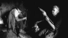 Asunci�n Antelo, fiando li�o co seu irm�n, na lareira de Segufe, no ano 1991