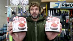 David, de Autorecambios Tambre, muestra dos modelos de balizas v16 homologadas.