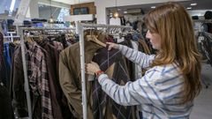 Una dependienta ense�a una de las prendas de punto en la tienda Pillados, en Boiro.