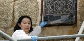 Mar�a V�zquez muestra el deterioro de la parte inferior de un vitral y detallle de la restauraci�n.