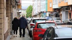 La calle Reis Católicos, actualmente con coches aparcados junto a las dos aceras. 