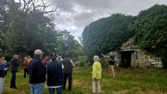 El escritor Jos� Mar�a Lago (al fondo, a la derecha) dirigi� una visita guiada al edificio que alberg� la antigua escuela de la parroquia de Pinol, que estuvo activa durante cerca de un siglo y medio