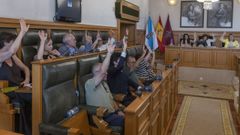 Momento en el que los seis concejales socialistas -en la fila superior- votan en el pleno junto a los del BNG y Compostela Aberta
