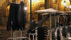 Un camarero retira mesas de una terraza de Oviedo