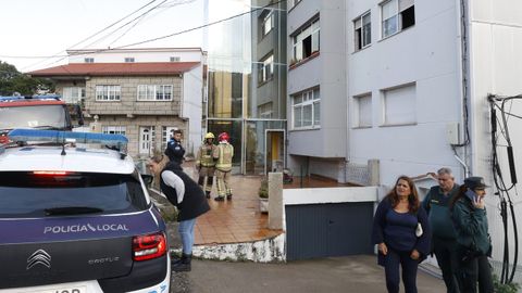Policas, bomberos y Guardia Civil seguan esta maana de sbado en el edificio de Bueu en el que se registr el incendio, adonde acudieron vecinos